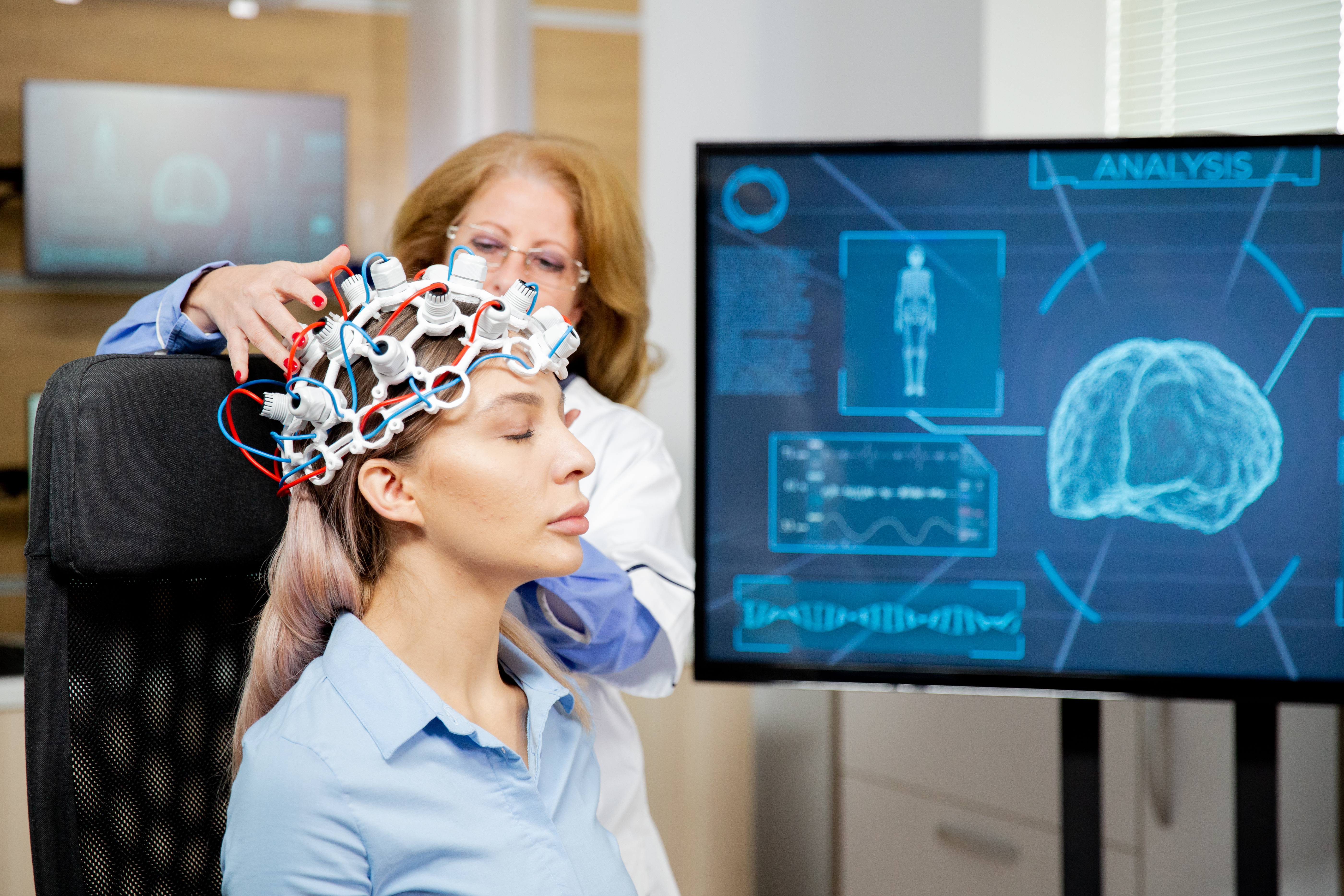 doctor arranging scanning device head female patient